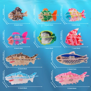 Various acetate fish hair claws including sharks and tropical fish on water background