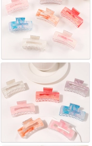 Detail view of large marble texture hair claws in various elegant pastel colors