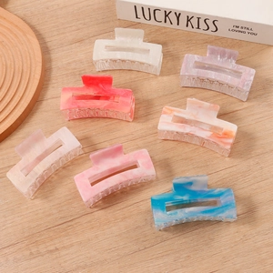 Set of seven colorful marble pattern hair claws in elegant resin for French style hair styling