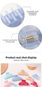 Detail of smooth polished teeth and strong metal spring on marble hair claw clips