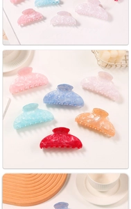 Detail of colorful acetate hair claws with marble texture in various vibrant jelly colors
