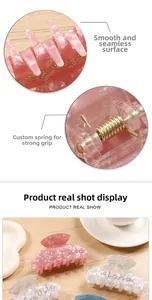 Macro detail of marble textured hair claw clip with rhinestones and durable spring metal