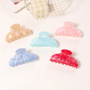 Five colorful gradient jelly acetate hair claws in pastel champagne, blue, pink, and red