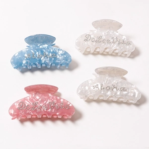 Set of four luxury acetate hair claws with water ripple texture and sparkly letter accents