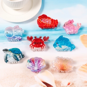 Eight colorful ocean theme hair claws featuring crab lobster and dolphin designs
