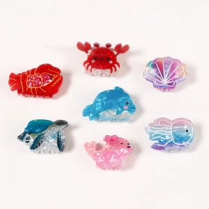 Set of seven marine animal hair claws including crab and dolphin shapes with marble texture