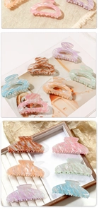 Close-up of elegant macaron hair claws with marbled textures in various pastel colors
