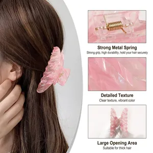Pink butterfly hair claw clip with iridescent finish and strong golden metal spring