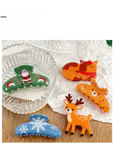 Detail showing Christmas hair claw clips with reindeer, snowflake and santa claus designs