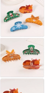 Detailed view of colorful Christmas hair claws with cat, reindeer and snowflake patterns