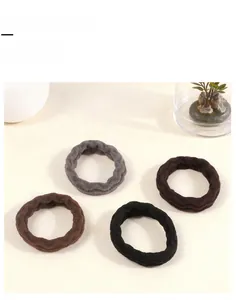 Set of four plush high-elasticity hair ties in grey, brown, dark brown, and black shades