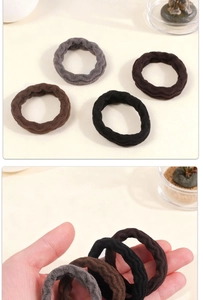 Detailed close-up of plush elastic hair ties in neutral colors showing soft wavy texture
