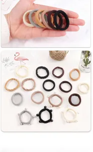 Detailed close-up of earth-toned high elastic hair bands set with pearl accents