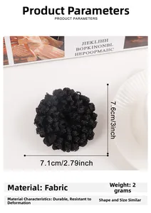 Detail of black plush scrunchie showing fabric texture and 7.1cm to 7.6cm diameter size
