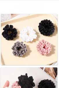 Detailed view of high-elastic plush scrunchies in assorted colors on a beige display plate