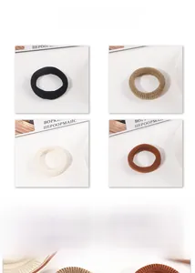 Detail of four colorful high-elasticity ribbed knit hair ties in a stylish flat lay set