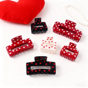 Chic heart pattern hair claws set in black red and cream colors for elegant hair styling