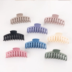 Large matte claw clips in eight colors including black, white and purple displayed on white