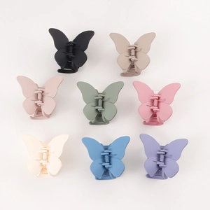 Set of 8 colorful matte butterfly hair claws in various Morandi tones on white background
