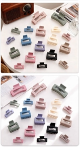 Detailed collection of colorful matte large hair claws in various shapes on a desktop