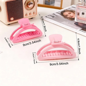 Set of two pink macaron-colored hair claws in a streamlined semicircular shark clip design