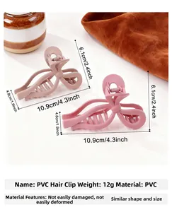 Détail d'une grande pince à cheveux nœud en PVC mat, dimensions 10,9x6,1x4,8cm et 12g