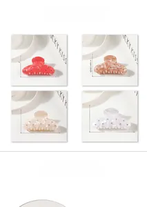 Detailed view of hair claw clips in four colors with dimensions 8.4cm x 4.1cm and rhinestones