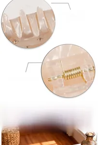 Detail of marble pattern acetate hair claw with rhinestones and sturdy metal spring