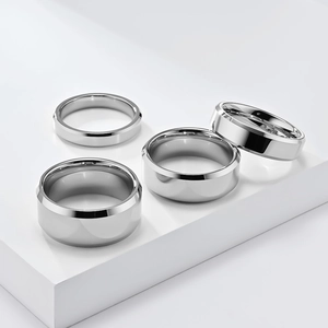 Polished silver tungsten rings with beveled edges in four different widths on stands