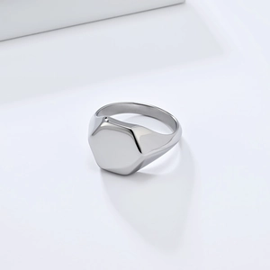 Polished silver hexagonal signet ring made of minimalist stainless steel on white background