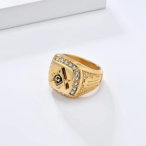 Detailed close-up of golden Freemasonry ring with G logo and cubic zirconia inlays