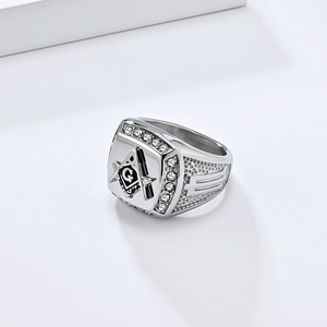 Macro shot of silver Masonic ring featuring square and compass symbol with CZ crystals