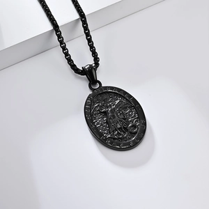 Vintage black Saint Michael stainless steel pendant necklace on a geometric white backdrop