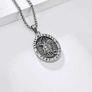 Vintage Saint Michael Archangel stainless steel pendant necklace on white stairs