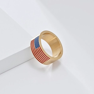 Close-up of golden stainless steel ring featuring American flag enamel star and stripe details