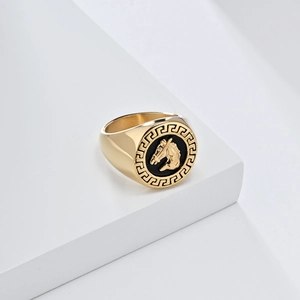 Vintage gold horse head signet ring with Greek meander border on white podium