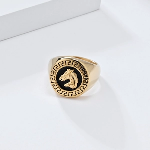 Detailed macro shot of vintage gold horse head signet ring with Greek key pattern