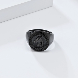 Macro detail of men's black horse head signet ring with Greek meander pattern edge