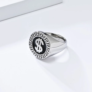 Macro detail of silver dollar sign ring with Greek key pattern on a wide band
