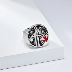 Macro view of vintage steel Crusader knight ring featuring a red shield and sword