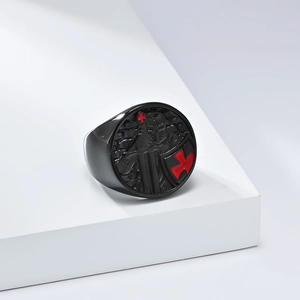 Detail of black stainless steel signet ring with embossed crusader knight and red cross