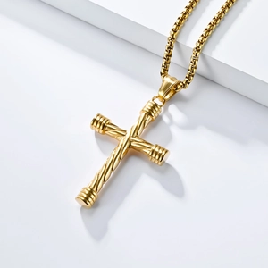 Detail of a golden twisted rope cross pendant with a durable box chain on a white platform