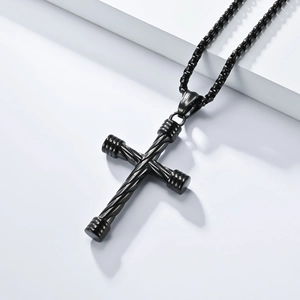 Detail of black stainless steel cross pendant with twisted rope texture and industrial style