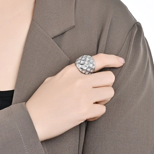 Polished silver textured lattice sphere ring for women worn on grey blazer sleeve