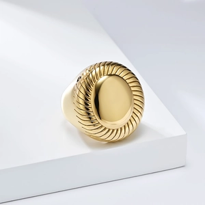 Macro detail of gold-plated titanium steel ring with spiral texture on geometric base