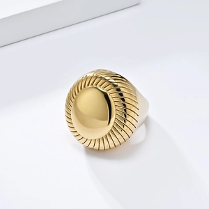 Bold titanium steel gold-plated ring featuring a polished disc and radial texture