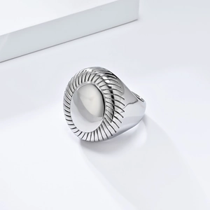 Minimalist silver stainless steel ring with a round radial pattern and smooth center