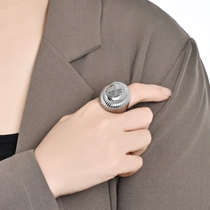 Exaggerated silver chunky ring with spiral radial pattern in a minimalist metal design