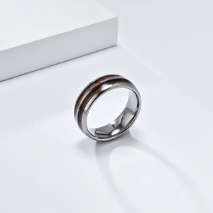 Macro shot of polished tungsten steel ring with elegant double wood grain inlay detail