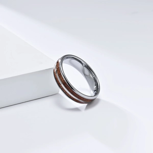 Detail view of tungsten carbide ring with polished finish and natural wood grain inlay